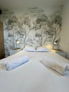 a bedroom with two pillows on a white bed at Hôtel Restaurant le clos de l 'Ancien Pressoir in Commes