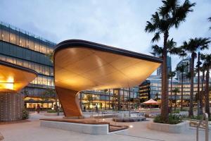 a large building with a wooden structure in a city at A Spacious 2BR Apt with an Amazing View Over Darling Harbour in Sydney