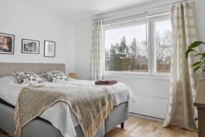 a bedroom with a bed and a large window at Happy house in Helsinki