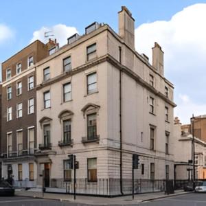 a large white building on the corner of a street at Stylish Spacious Retreat Luxury 2 Bedroom Haven 2 in London