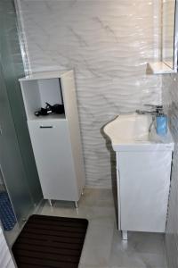 a white bathroom with a sink and a mirror at Carla Apartment Opuzen Modern Oasis and Comfort in Opuzen +72 photos