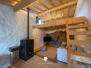 a loft bed with a stove in a room at Casa do Bernardino in Cabril