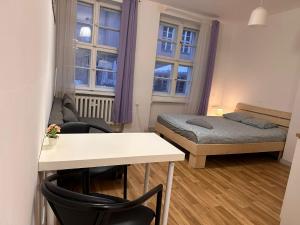 a small room with a bed and a table at Kozia 24/25 in Poznań