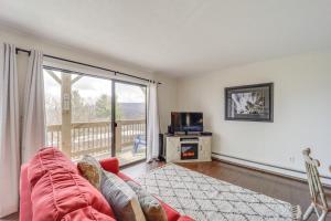 a living room with a couch and a large window at Beech Mountain Studio with Balcony Less Than 1 Mi to Skiing! in Beech Mountain