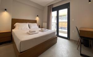 a bedroom with a bed with two towels on it at Toumba apartments in Thessaloniki