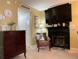 a living room with a tv and a chair and a fireplace at Gatlinburg Summit Studio for 2 With Amazing View! in Gatlinburg