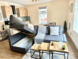 a living room with a couch and a piano at DVMescape flat1 in Bristol