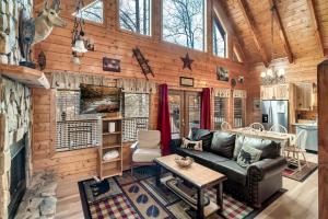 a living room with a leather couch in a log cabin at Private! Hot Tub, Views, & Games in Sevierville