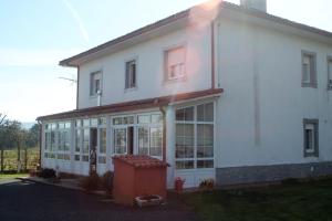 ein großes weißes Haus mit einem großen Fenster in der Unterkunft A casa de Dora da Estrada in A Estrada