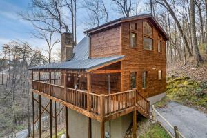 a wooden house with a porch and a deck at Private! Hot Tub, Views, & Games in Sevierville