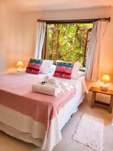 a bedroom with two beds with towels on them at Pousada Flor Do Mar in Caraíva