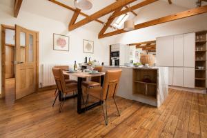 a kitchen and dining room with a table and chairs at The Old School in Edlingham