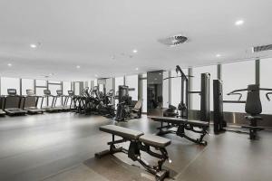 ein Fitnessstudio mit vielen Laufbändern und Maschinen in der Unterkunft A Lux & Modern Apt Next to Southern Cross Station in Melbourne