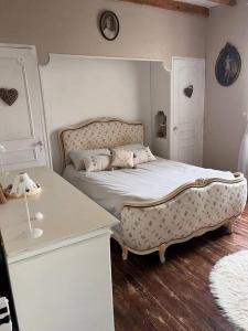 een slaapkamer met een bed en een tafel. bij La périgourdine et son spa in Saint-Cyprien