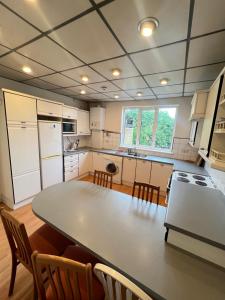 a large kitchen with a table and chairs in it at Sweet Homes in London