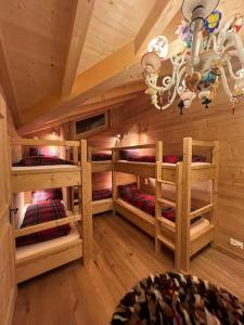 a room with three bunk beds in a cabin at Chalet Riedhuus in Davos Wolfgang