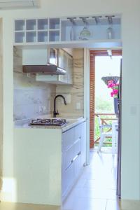 a kitchen with a sink and a stove top oven at fantástico, paraíso, mar, atardeceres, playa, Paz in San Silvestre