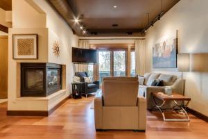 a living room with a couch and a fireplace at Stunning Coeur dAlene Condo Walk Downtown in Coeur d'Alene