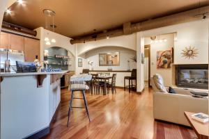 a kitchen and living room with a couch and a table at Walk Downtown Stunning Condo with Attached Garage in Coeur d'Alene