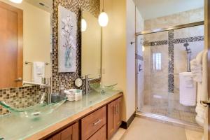 a bathroom with a sink and a shower at Walk Downtown Stunning Condo with Attached Garage in Coeur d'Alene +29 photos