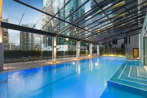 a large swimming pool inside of a building at A Large 2BR Apt Near Crown Sleeps 8 FREE Parking in Melbourne