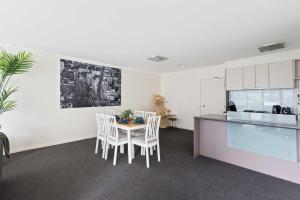 a kitchen and dining room with a table and chairs at A Large 2BR Apt Near Crown Sleeps 8 FREE Parking in Melbourne