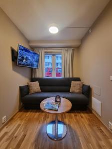 a living room with a couch and a table at Central Apartment Ålesund in Ålesund