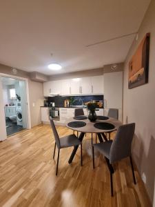 a kitchen and dining room with a table and chairs at Central Apartment Ålesund in Ålesund
