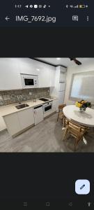 a kitchen with a table and a sink and a table and a table at Casa la florida in Puebla de Sanabria