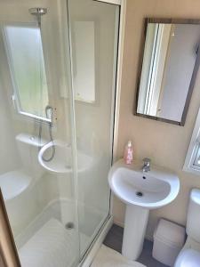 a bathroom with a shower and a sink at Three bedroom holiday home in Whitstable