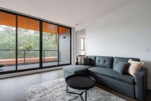 a living room with a blue couch and a table at A 3BR Apt Next to Melbourne Zoo FREE Parking in Melbourne