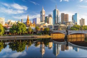a city skyline with a bridge over a river at A 3BR Apt Next to Melbourne Zoo FREE Parking in Melbourne