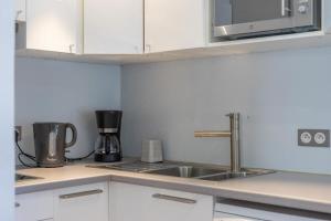 a kitchen with a sink and a coffee maker at Starton furnished flat in Chamonix