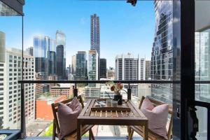 墨尔本A 3BR Apt Next to Southern Cross FREE Parking的配有桌椅的阳台，可欣赏城市景观