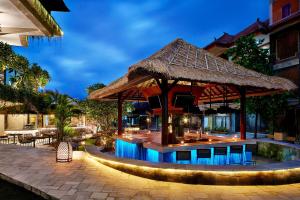 a resort with a swimming pool with a gazebo at Four Points by Sheraton Bali, Kuta in Kuta