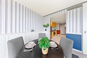 a dining room with a black table and chairs at Comfy CBD Apt in QV with City Views FREE Parking in Melbourne