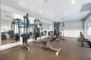a gym with cardio equipment in a large room at Comfy CBD Apt in QV with City Views FREE Parking in Melbourne