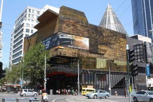 a building with a car on the side of it at Comfy CBD Apt in QV with City Views FREE Parking in Melbourne