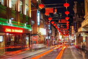 a city street at night with red lanterns at Comfy CBD Apt in QV with City Views FREE Parking in Melbourne