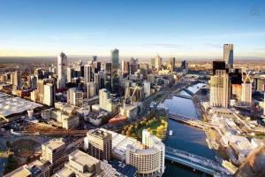 an aerial view of a city with a river and buildings at Comfy CBD Apt in QV with City Views FREE Parking in Melbourne