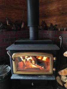 a stove with a fire inside of it at log Hotel kamloops in Shinano