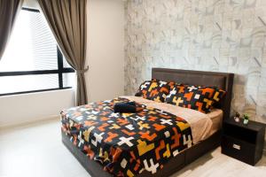 a bedroom with a bed with a colorful comforter at Modern, High Floor Suasana Suites 05 in JB in Johor Bahru +24 photos