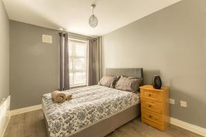 a bedroom with a dog laying on a bed at Modern Elegant Central Apt with Parking in Dublin