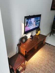 a tv sitting on a wooden table with a television on it at MOA Shore 3 tower 2 in Manila