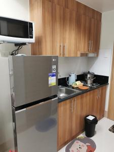 a kitchen with a stainless steel refrigerator and a sink at MOA Shore 3 tower 2 in Manila