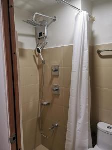 a bathroom with a shower with a shower curtain at MOA Shore 3 tower 2 in Manila