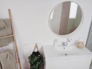 a bathroom with a white sink and a mirror at Apartamento Casa Rosabella in Caleta de Sebo +10 photos