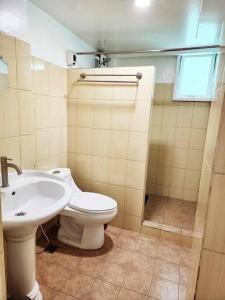 a bathroom with a toilet and a sink at City Oasis: Steps Away from Urban Buzz in Baguio