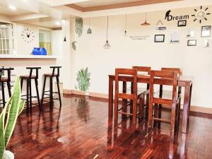 a group of chairs and a table in a room at City Oasis: Steps Away from Urban Buzz in Baguio