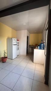 a kitchen with a white refrigerator in a room at Amplio y moderno apartamento de 1 habitación in Tegucigalpa